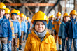 © Констянтин Батыльчук - Little girl in yellow jacket and yellow hard hat standing in front of group of people.