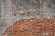 The walls are peeling the red bricks are visible texture background.