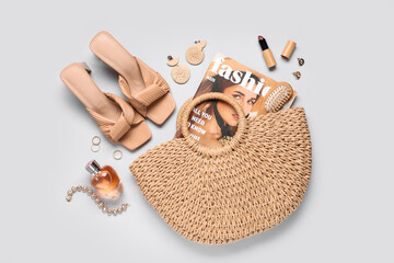 Wall Mural - Beautiful composition with wicker bag, magazine and accessories on light background