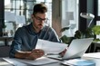 © SHI - A busy young professional businessman checks documents on his laptop in his office. Serious business accounting experts in the workplace read legal documents overview of company documents.