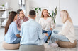 © Pixel-Shot - Smiling mature woman talking at group therapy session