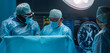 Team of medical doctors performs surgical operation in modern operating room using high-tech technology. Surgeons are working to save the patient in the hospital. Medicine, health and science.