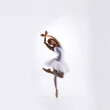 © Acronym - Ballet dancer isolated on white. Beautiful ballerina performing in studio.