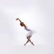 © Acronym - Ballet dancer isolated on white. Beautiful ballerina performing in studio.