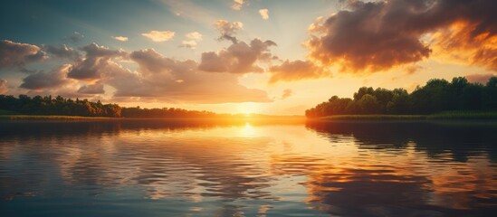 Poster - A serene lake at sunset with clouds and trees