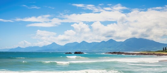 Poster - Beach with towering mountain backdrop