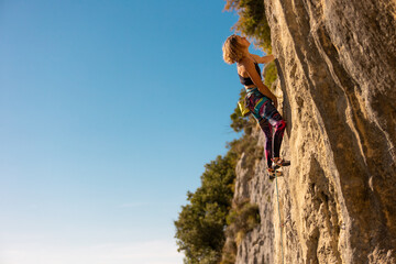 Wall Mural - The girl climbs the rock.