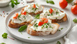 © Oleksiy - Plate of tasty toasts with cream cheese on white tile background