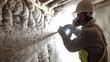© Suralai - Shot of worker blowing loosefill insulation into wall cavity.generative ai