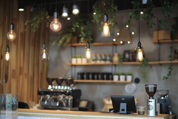 Poster - Interior of a bar with multiple light bulbs hanging from the ceiling. Suitable for interior design concepts