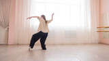 Fototapeta Zwierzęta - Caucasian woman dancing contemporary in ballet class. Rehearsal.