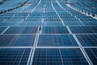 Rows of solar panels adorning the rooftop of a warehouse, contributing to a greener environment.