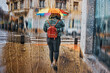Pedestrian on the street with an umbrella in rainy days in winter season