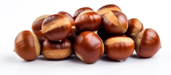 Poster - A small mountain of brown chestnuts on a white table