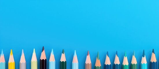 Aufkleber - Colored pencils on blue backdrop