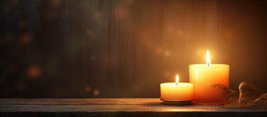 Poster - Two candles on wooden surface with foliage against dark backdrop