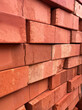 Stacked red clay bricks for construction