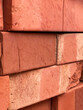 Stack of red clay bricks close-up