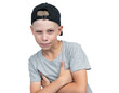 Portrait of a sly squinting teenage boy in a baseball cap, isolated on a transparent background png