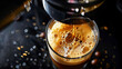 Close up of process of pouring of freshly brewed espresso coffee in coffee machines into glass cup
