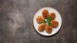 Fried meat cutlets in a plate on a dark grunge background. Top view, copy space, banner.