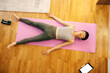 Top view of a japanese woman lying down on yoga mat and relaxing.