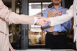 Successful negotiation, handshake, two businessmen shaking hands with partners to celebrate successful completion of deal