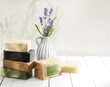 Natural handmade soaps on white wooden table background