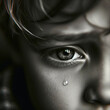 A teenager boy's eyes filled with tears. The image captures the innocent and emotional expression of the child with clear tears welling. Close-up of a boy's face. Tears. Emotion concept.