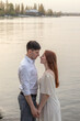 © Mikhail - Young couple in love standing by the lake. Love concept