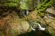 Beautiful waterfall on the Černohorský stream in the lush green summer forest near Janské Lázně in the Giant Mountains in the Czech Republic