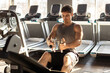 © Home-stock - Muscular man exercising in gym, training hard and pulling weights in seated cable row machine. Bodybuilder, fitness concept