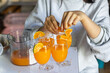 selective focus tangerine slices on the lip of a glass of freshly squeezed orange juice Fresh fruit juice drinks from the orange orchard to taste orange juice.