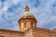 Majestic dome of Palermo Cathedral against blue sky in southern Italy.