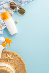 vertical flat lay of summer sun protection items including sunscreen spray, stylish sunglasses, and 