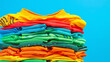 A pile of colorful shirts stacked on top of each other. The shirts are of different colors and sizes, creating a vibrant and lively scene. Concept of abundance and variety
