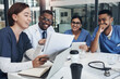 © peopleimages.com - Meeting, documents and team of doctors in office for medical treatment, diagnosis or surgery in clinic. Discussion, laptop and surgeon with healthcare interns learning with paperwork in hospital.