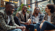© NooPaew - Multicultural businesspeople working in an office lobby. Group of happy businesspeople smiling while sitting together in a co-working space. Young entrepreneurs collaborating on a new project.