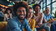 © NooPaew - Multicultural businesspeople working in an office lobby. Group of happy businesspeople smiling while sitting together in a co-working space. Young entrepreneurs collaborating on a new project.