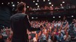 © Hope - A man stands in front of a large audience, giving a speech