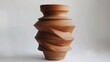 A clay vase with asymmetrical outs and unexpected protrusions challenging the idea of a traditional vessel..