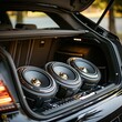 © Natalia - Installation of a custom subwoofer in a car trunk, focus on power and audio quality