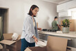 © peopleimages.com - Young couple, furniture and moving to home with boxes for renovation, investment or relocation. Partners, man and woman carrying plate for apartment interior, property rent or mortgage loan together