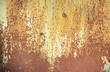 Paint peeling crackling off brown rusty metal texture background. Green paint peeling off rusty metal background. Design element.