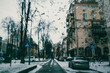 © vita - Car windshield with streams of water, melted snow in a cold autumn winter season. Abstract background. Concept of bad weather, rain, hurricane. View of a city street from inside the automobile, cars.