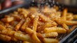 Potato fries are fried in a deep fryer.