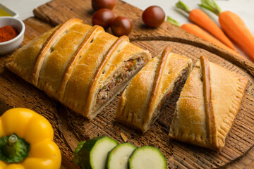 Wall Mural - Traditional Galician empanada filled with vegetables and anchovies. Traditional recipe from the northern part of Spain.