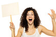 Young curly happy woman holding blank sign on white background.