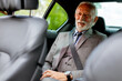 © BGStock72 - Distinguished senior gentleman enjoying a peaceful ride in a luxury car