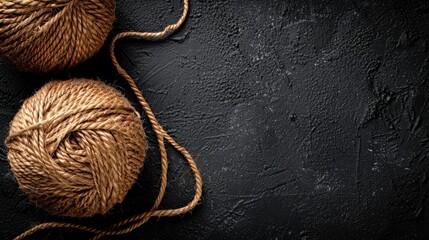 Wall Mural -   Two balls of yarn sit atop a black surface A third ball of yarn rests nearby, also on the black surface
